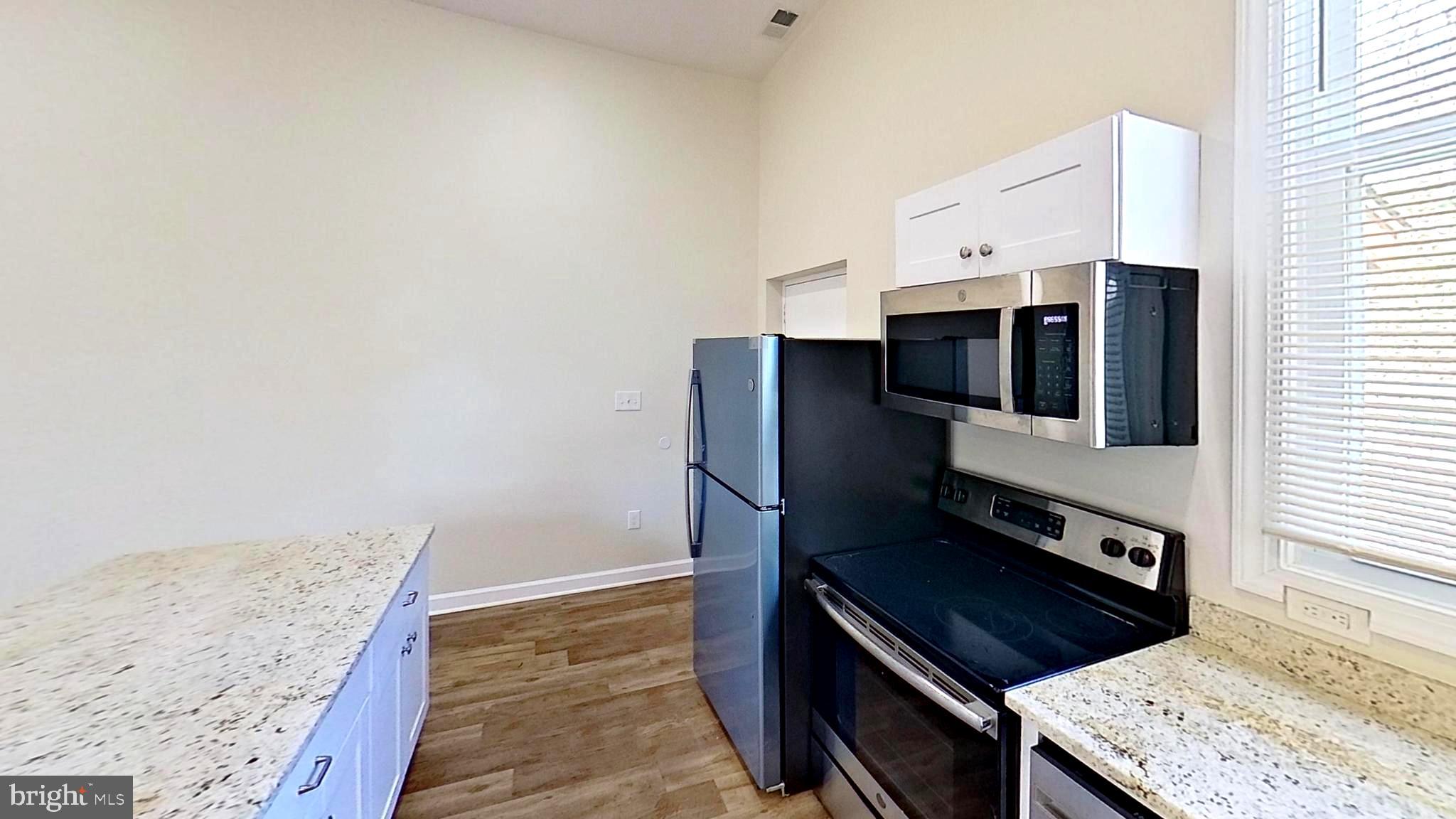 3842 Stoneybrook Road, Unit B White Plains, MD 20695 - Photo 21 of 23 a kitchen with stainless steel appliances granite countertop a stove and a refrigerator