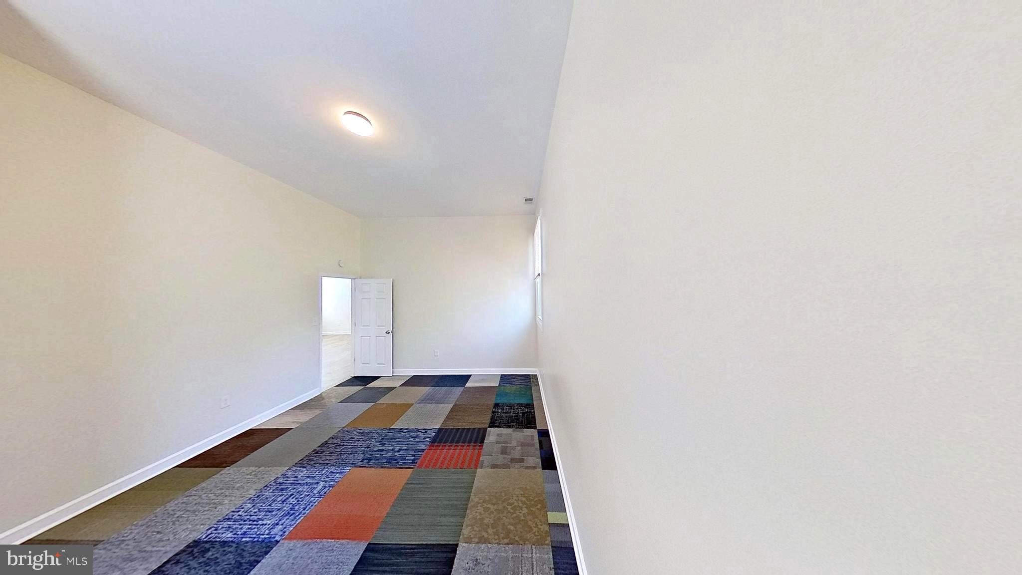 3842 Stoneybrook Road, Unit B White Plains, MD 20695 - Photo 8 of 23 a room with wooden floor and white walls
