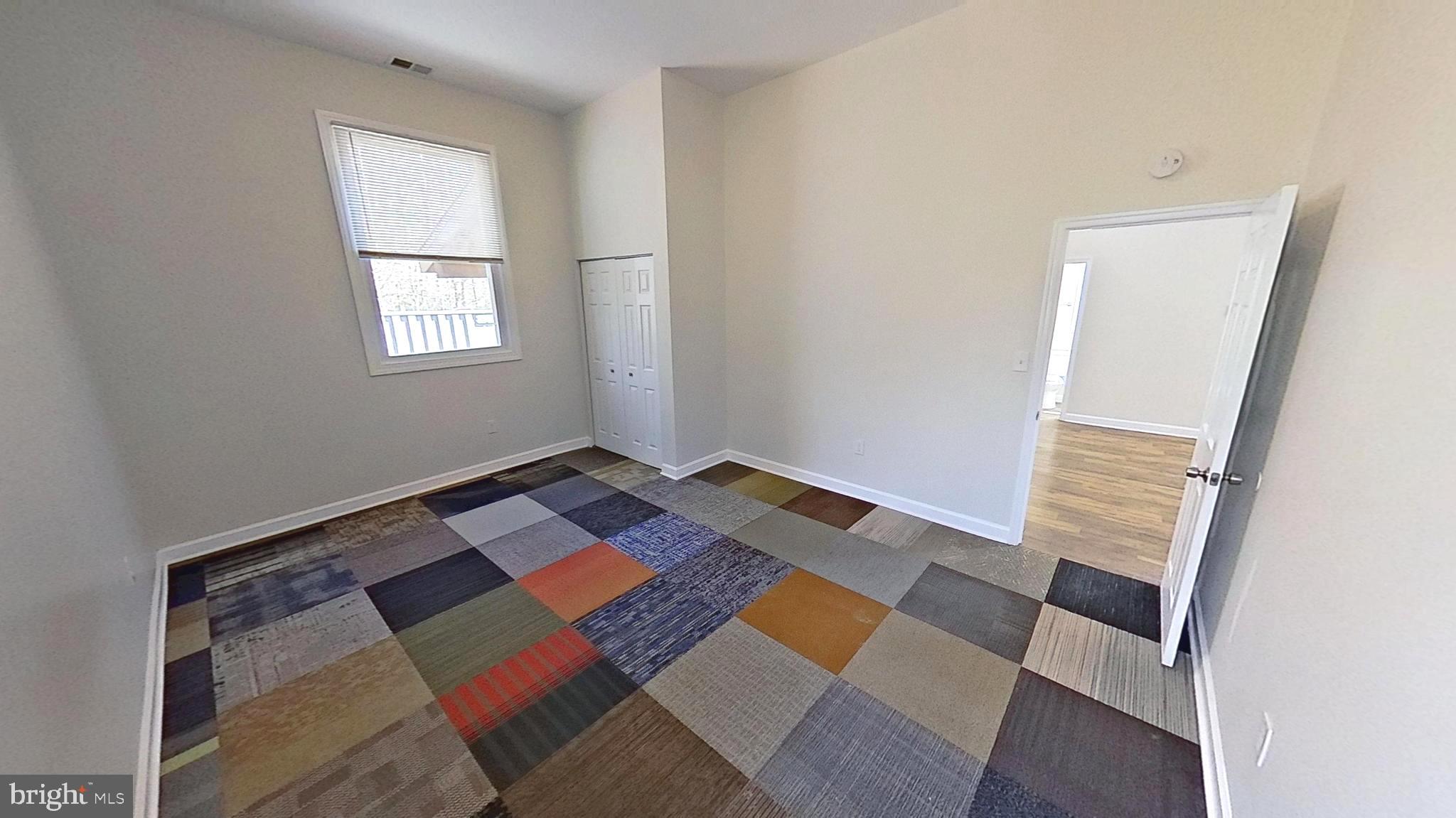 3842 Stoneybrook Road, Unit B White Plains, MD 20695 - Photo 10 of 23 a bed sitting in a bedroom next to a window