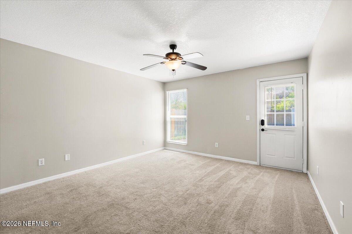 3255 Dowitcher Lane Orange Park, FL 32065 - Photo 19 of 39 a view of a room with a ceiling fan and a window