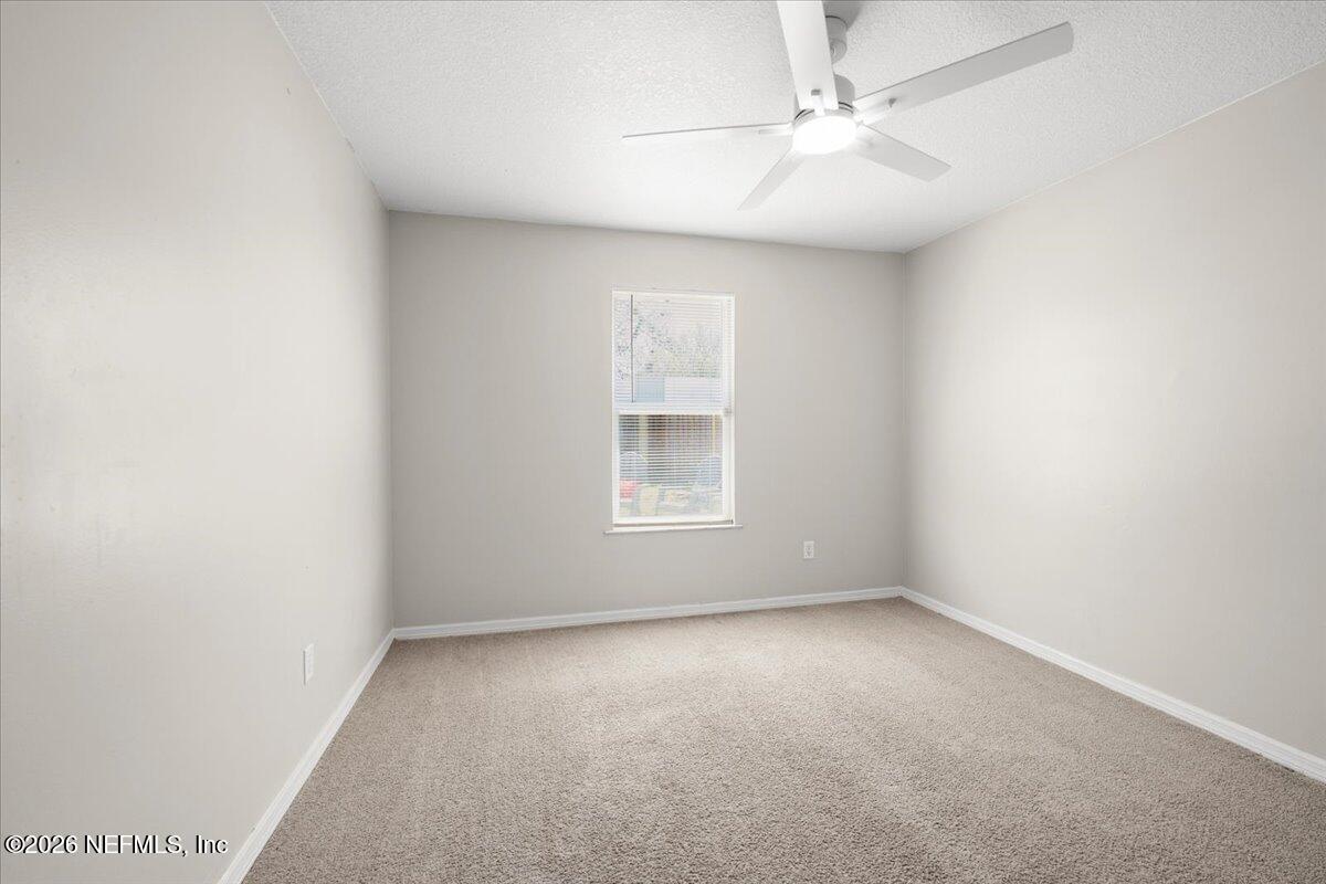 3255 Dowitcher Lane Orange Park, FL 32065 - Photo 24 of 39 an empty room with a window and a fan