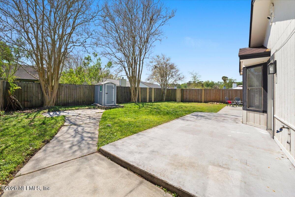 3255 Dowitcher Lane Orange Park, FL 32065 - Photo 35 of 39 a view of a backyard with a garden and trees