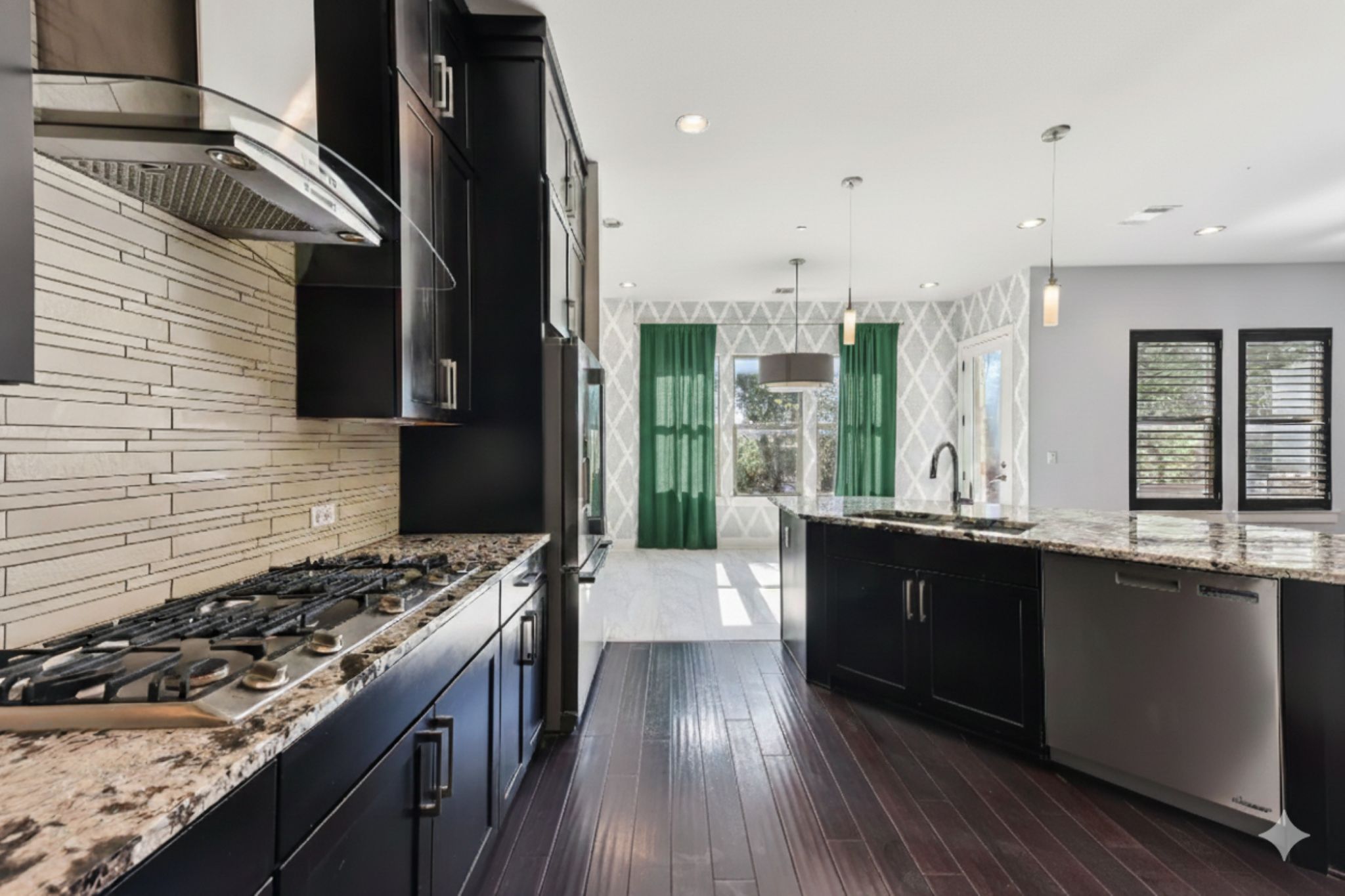 8110 Ranch Road 2222, Unit 98 Austin, TX 78730 - Photo 6 of 37 Kitchen with dark cabinetry, light stone counters, stainless steel appliances, pendant lighting, and recessed lighting