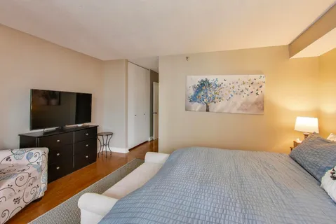 a bedroom with a bed and a flat screen tv