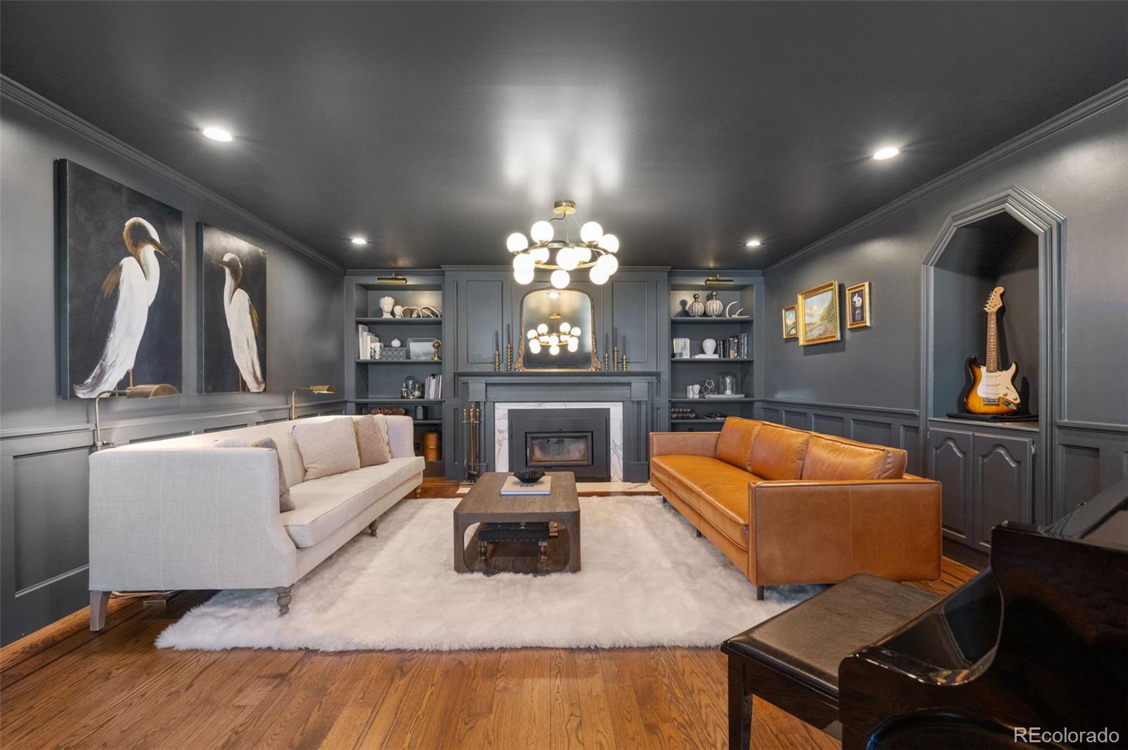 7225 West Box Canyon Road Sedalia, CO 80135 - Photo 13 of 49 a living room with furniture a large window and a fireplace