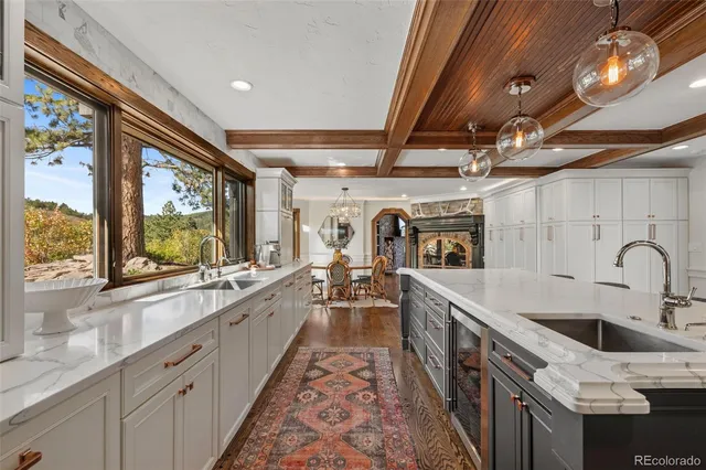 a large kitchen with stainless steel appliances granite countertop a sink and stove
