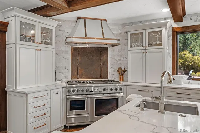 a kitchen with a stove oven and sink