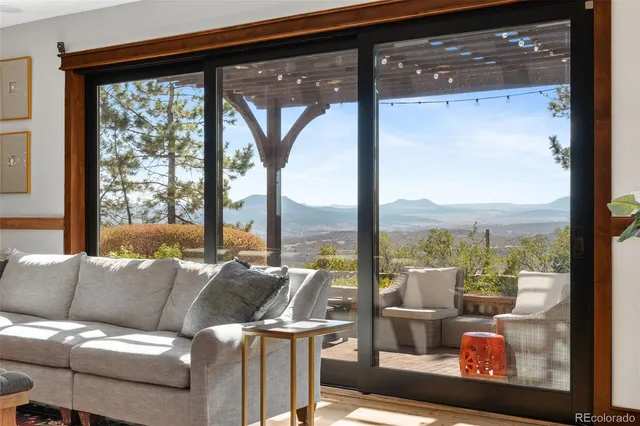 a living room with furniture and a floor to ceiling window