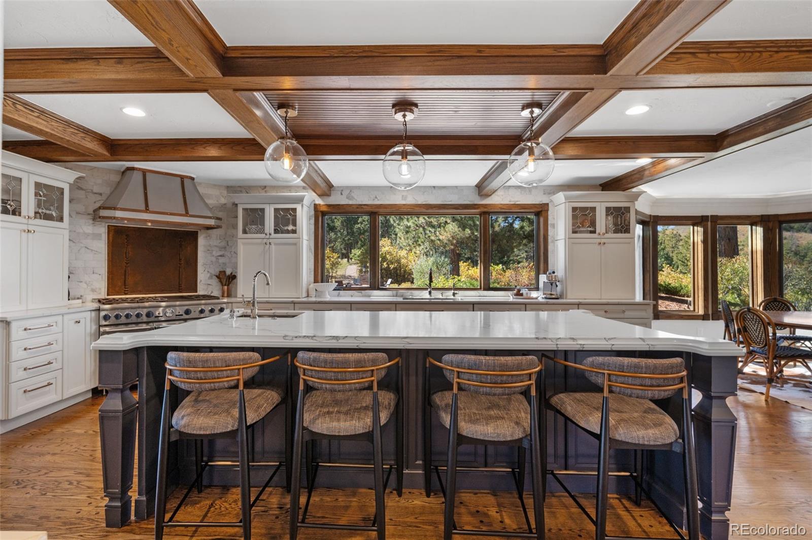 7225 West Box Canyon Road Sedalia, CO 80135 - Photo 2 of 49 a kitchen with a table and chairs in it