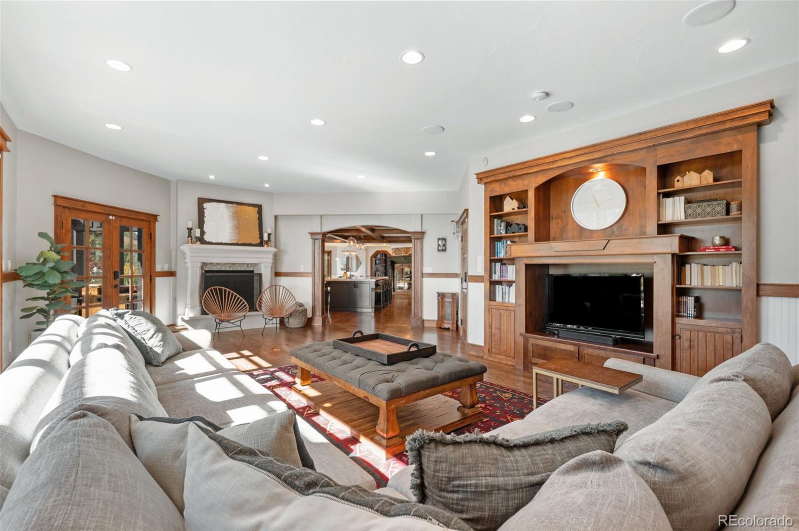 7225 West Box Canyon Road Sedalia, CO 80135 - Photo 21 of 49 a living room with furniture a fireplace and a flat screen tv
