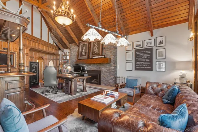 a living room with furniture a fireplace and a table