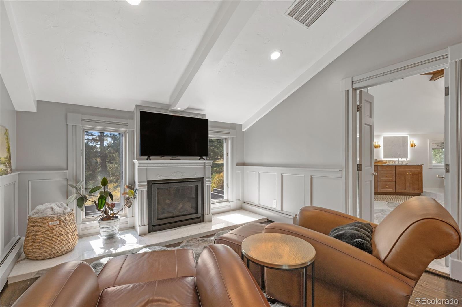 7225 West Box Canyon Road Sedalia, CO 80135 - Photo 29 of 49 a living room with furniture a flat screen tv and a fireplace