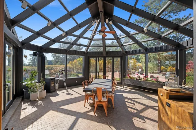 a dining room with furniture and a floor to ceiling window
