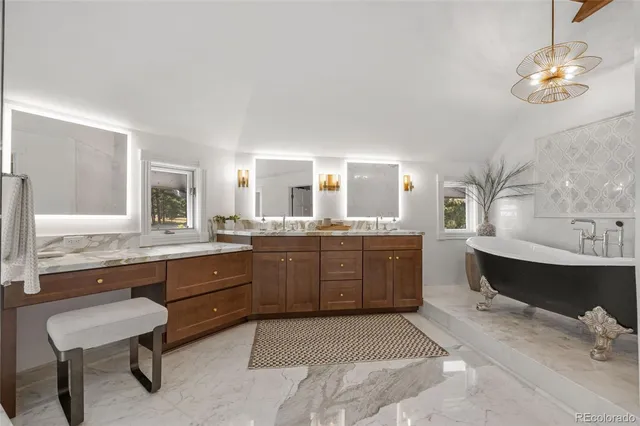 a bedroom with a bed lamps and a mirror