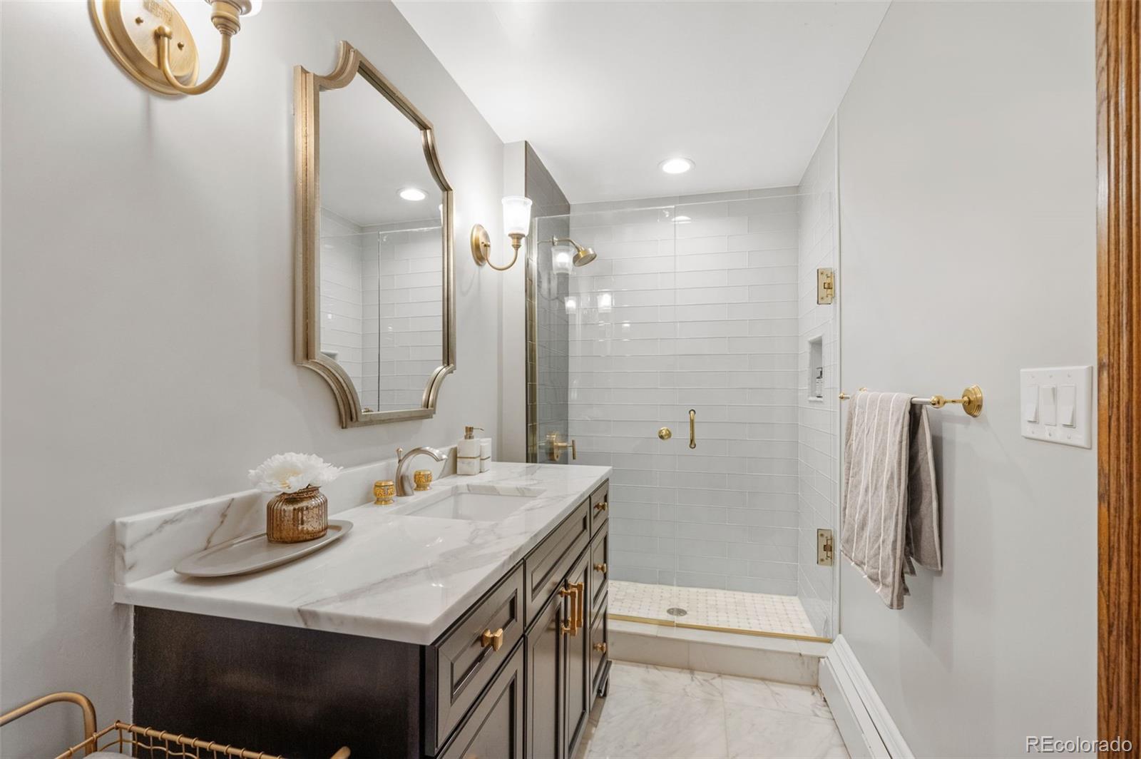 7225 West Box Canyon Road Sedalia, CO 80135 - Photo 37 of 49 a bathroom with a sink a toilet and shower