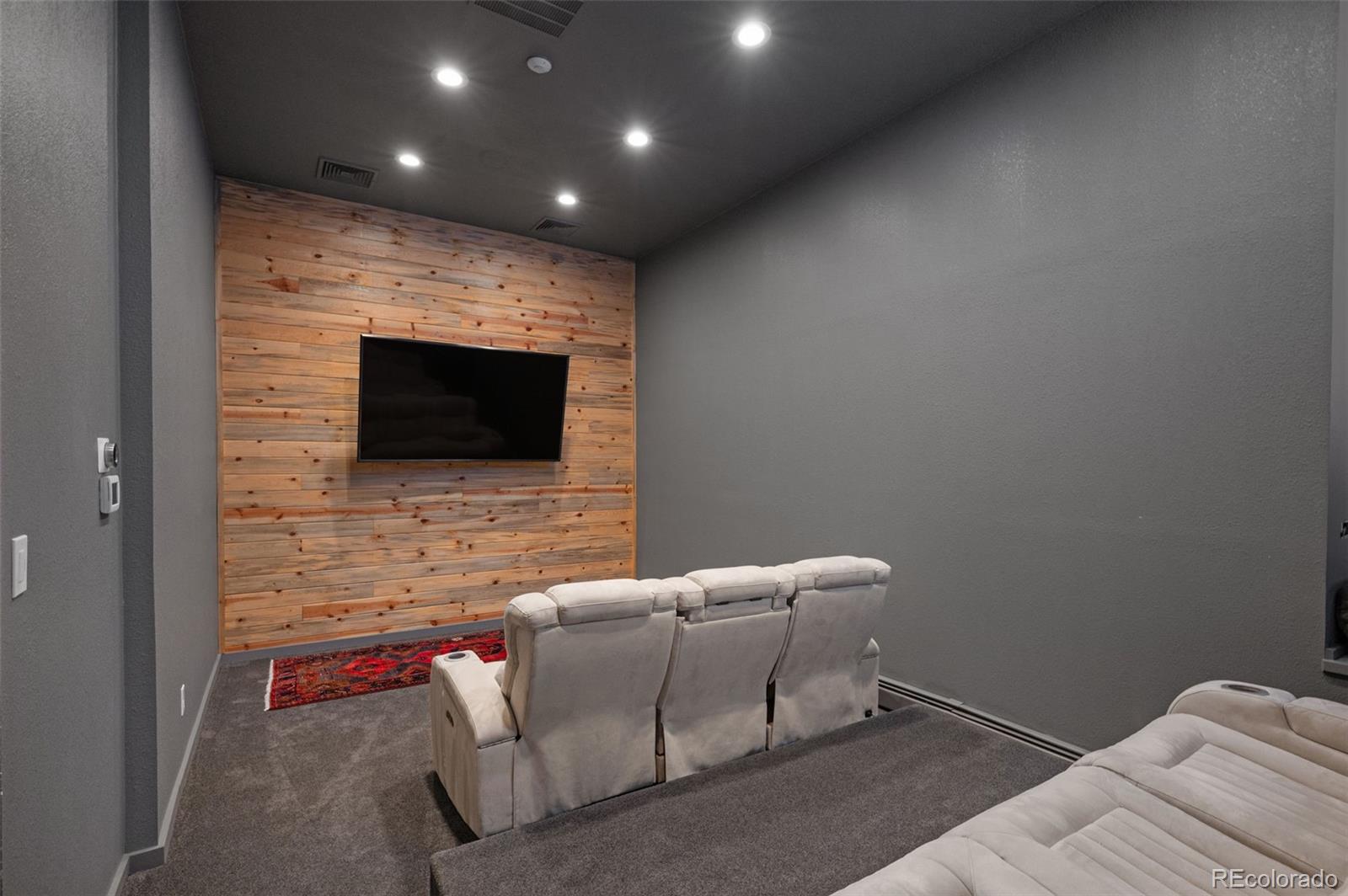 7225 West Box Canyon Road Sedalia, CO 80135 - Photo 39 of 49 a living room with furniture and a flat screen tv