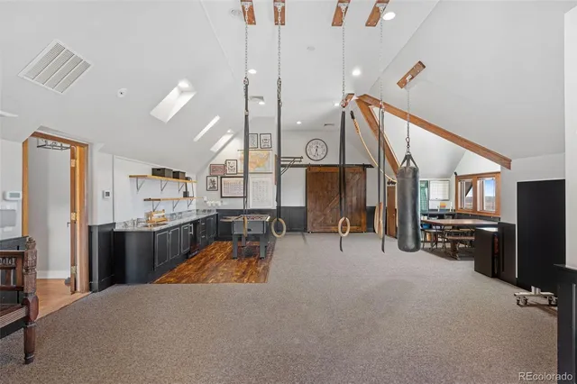 a living room with furniture a large window and a chandelier