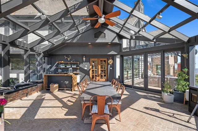a patio with a table and chairs under an umbrella