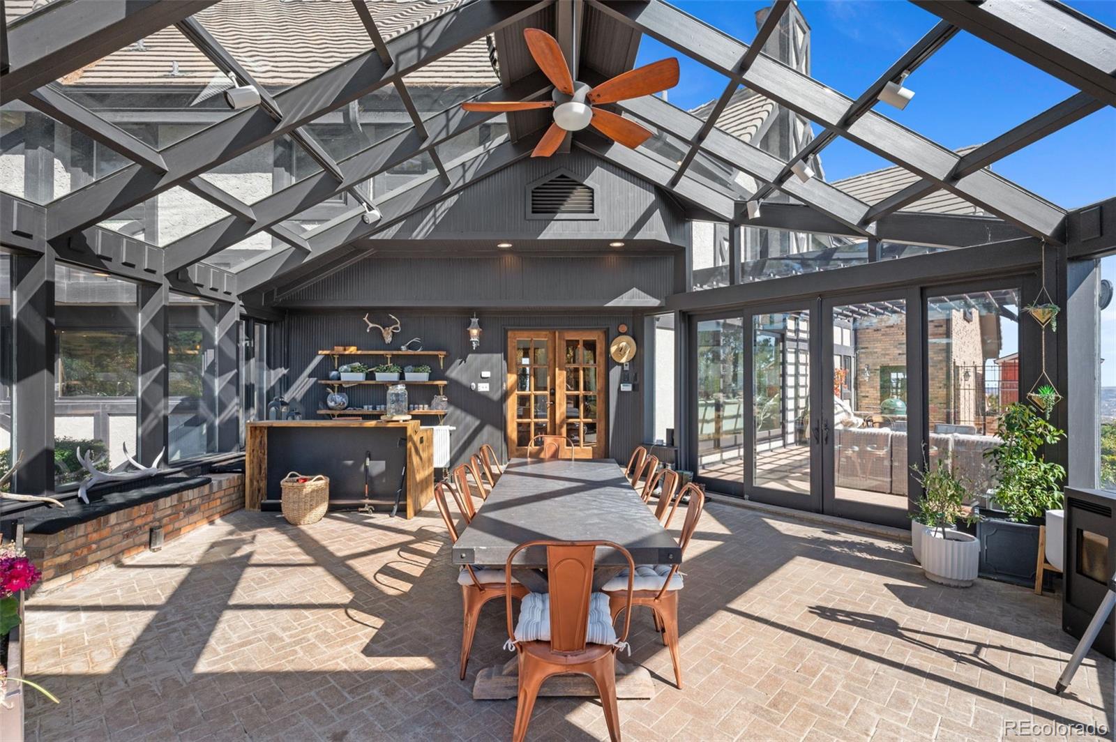 7225 West Box Canyon Road Sedalia, CO 80135 - Photo 43 of 49 a view of a patio with table and chairs potted plants