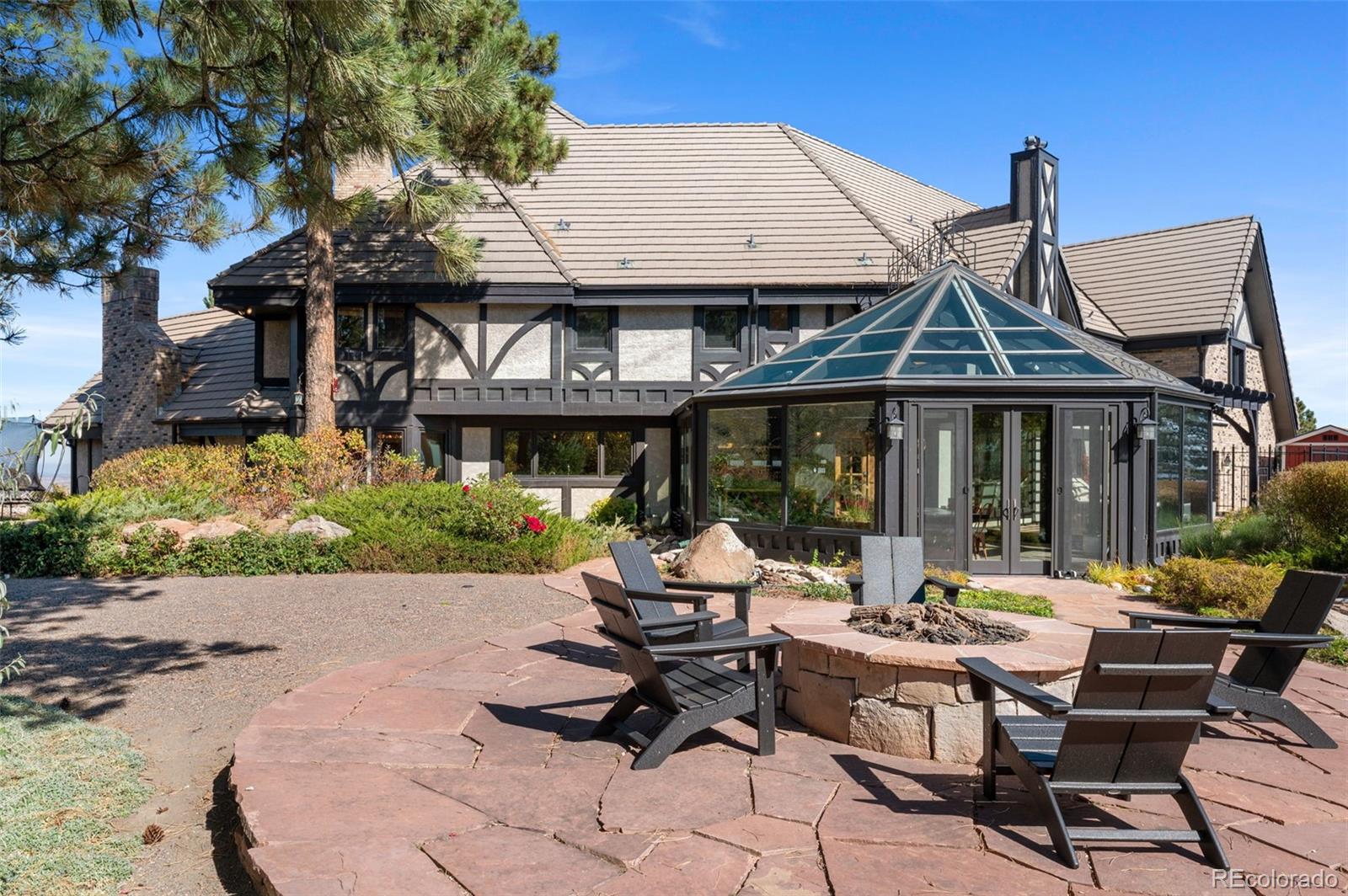 7225 West Box Canyon Road Sedalia, CO 80135 - Photo 44 of 49 a patio with a table and chairs under an umbrella