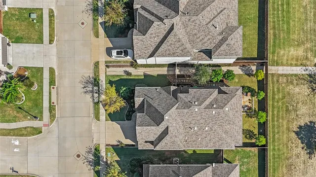 an aerial view of a residential houses with outdoor space