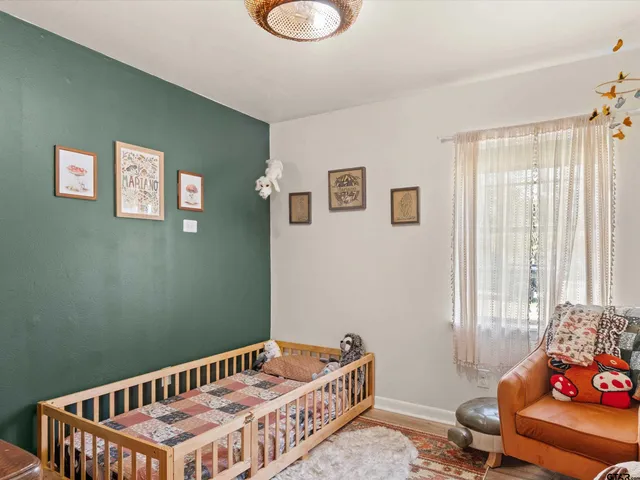 a bedroom with furniture and a window