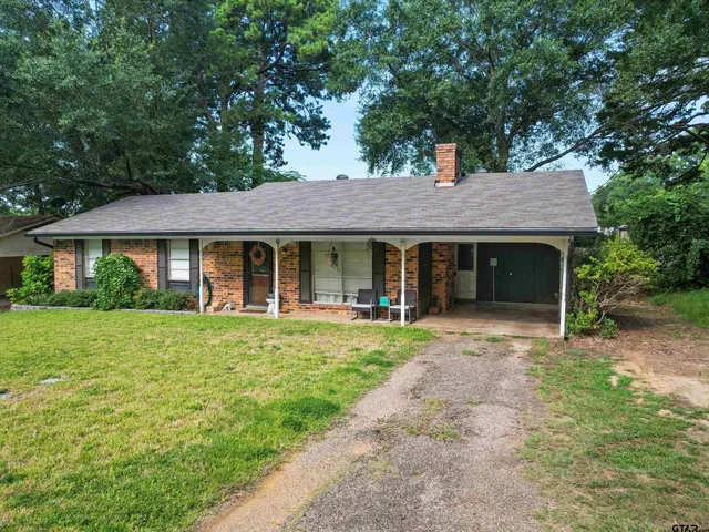 a front view of a house with a garden and porch
