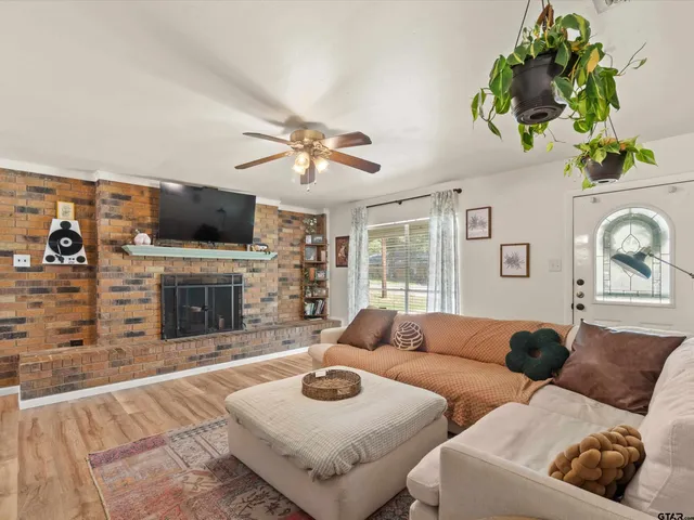 a living room with fireplace furniture and a flat screen tv