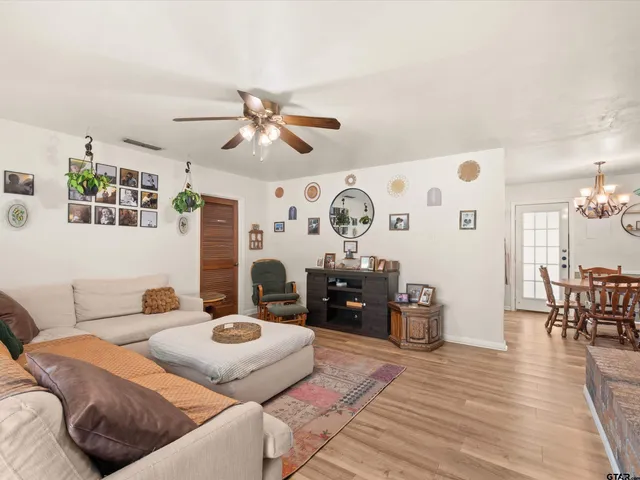 a bedroom with furniture and wooden floor