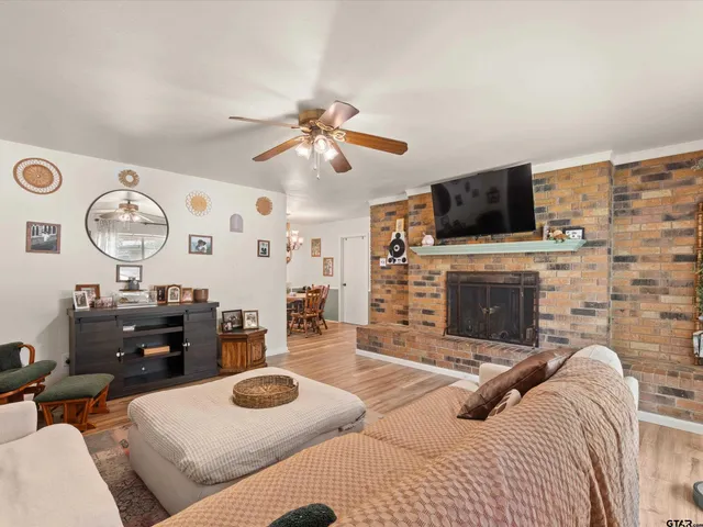 a bedroom with furniture a flat screen tv and a fireplace