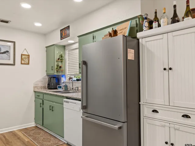 a white refrigerator freezer sitting inside of a kitchen
