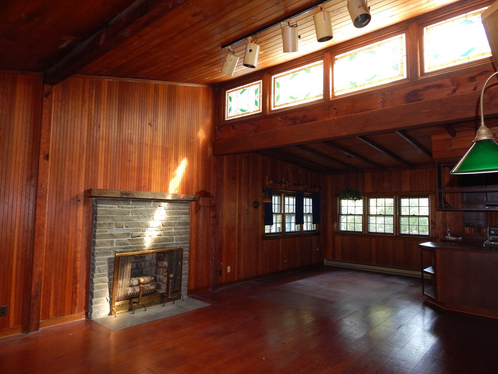 45 Plumtree Road Sunderland, MA 01375 - Photo 8 of 23 a view of an empty room with a fireplace and windows