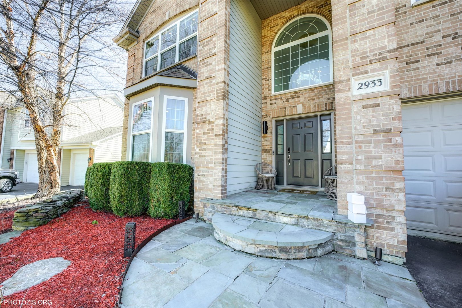 2933 Kelly Drive Elgin, IL 60124 - Photo 2 of 10 a view of a brick house with large windows