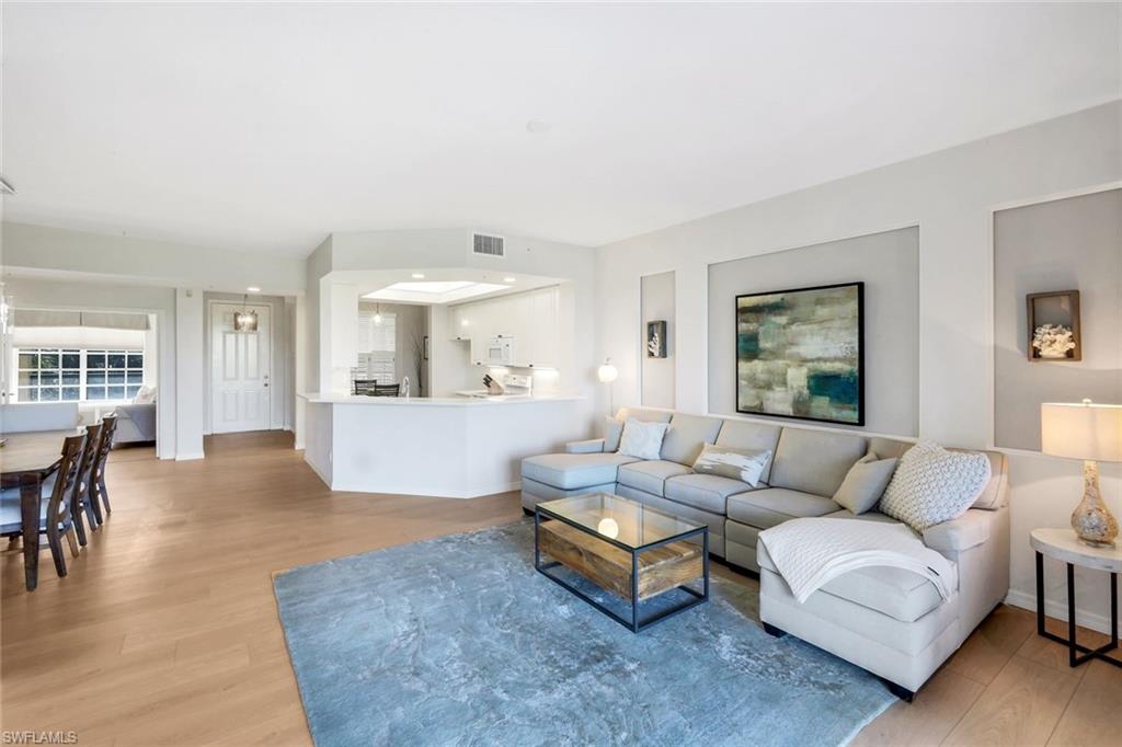 25161 Sandpiper Greens Court, Unit 203 Bonita Springs, FL 34134 - Photo 12 of 36 a living room with furniture and a large window