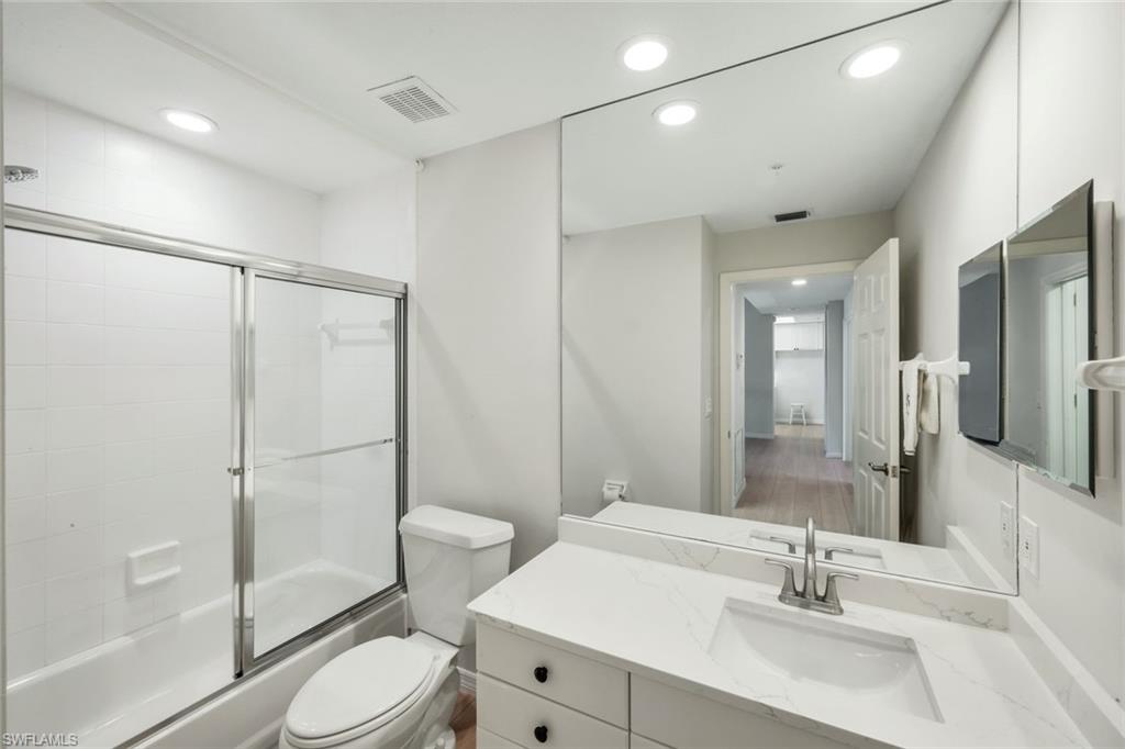 25161 Sandpiper Greens Court, Unit 203 Bonita Springs, FL 34134 - Photo 18 of 36 a bathroom with a sink a toilet and shower