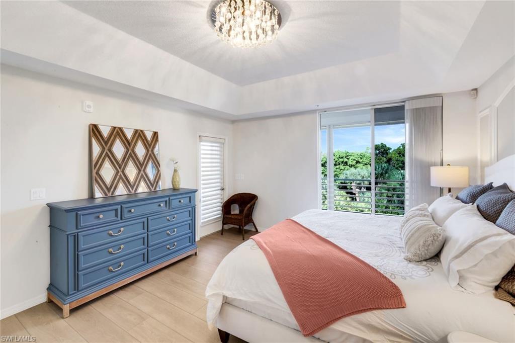 25161 Sandpiper Greens Court, Unit 203 Bonita Springs, FL 34134 - Photo 23 of 36 a bedroom with a bed and a dresser