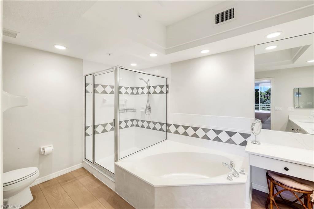 25161 Sandpiper Greens Court, Unit 203 Bonita Springs, FL 34134 - Photo 24 of 36 a bathroom with a bathtub and a sink