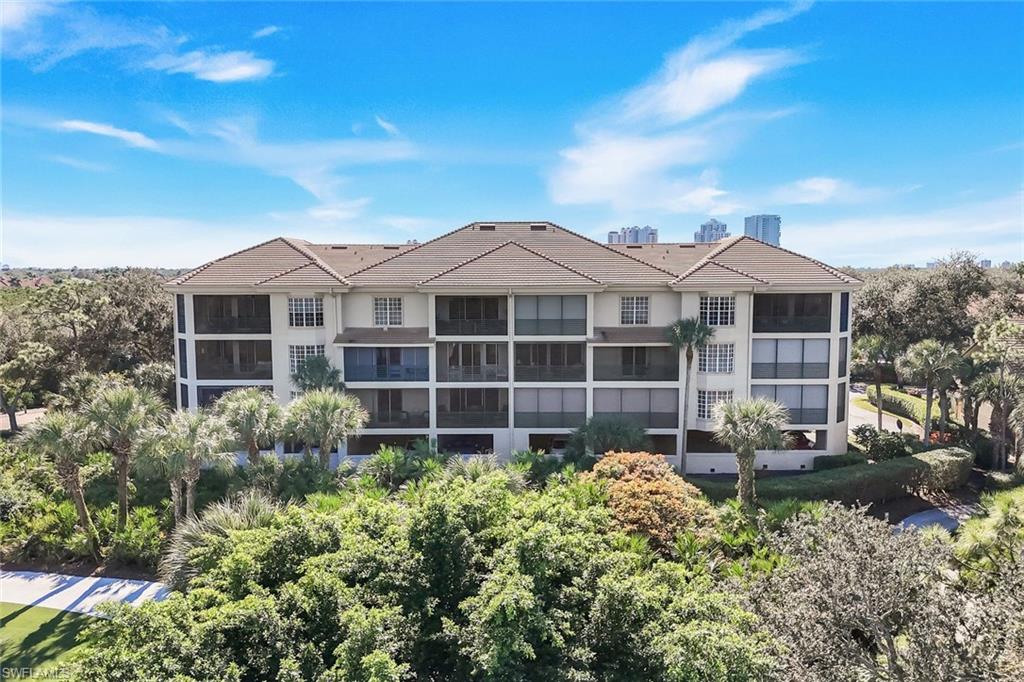 25161 Sandpiper Greens Court, Unit 203 Bonita Springs, FL 34134 - Photo 28 of 36 front view of a house with a garden