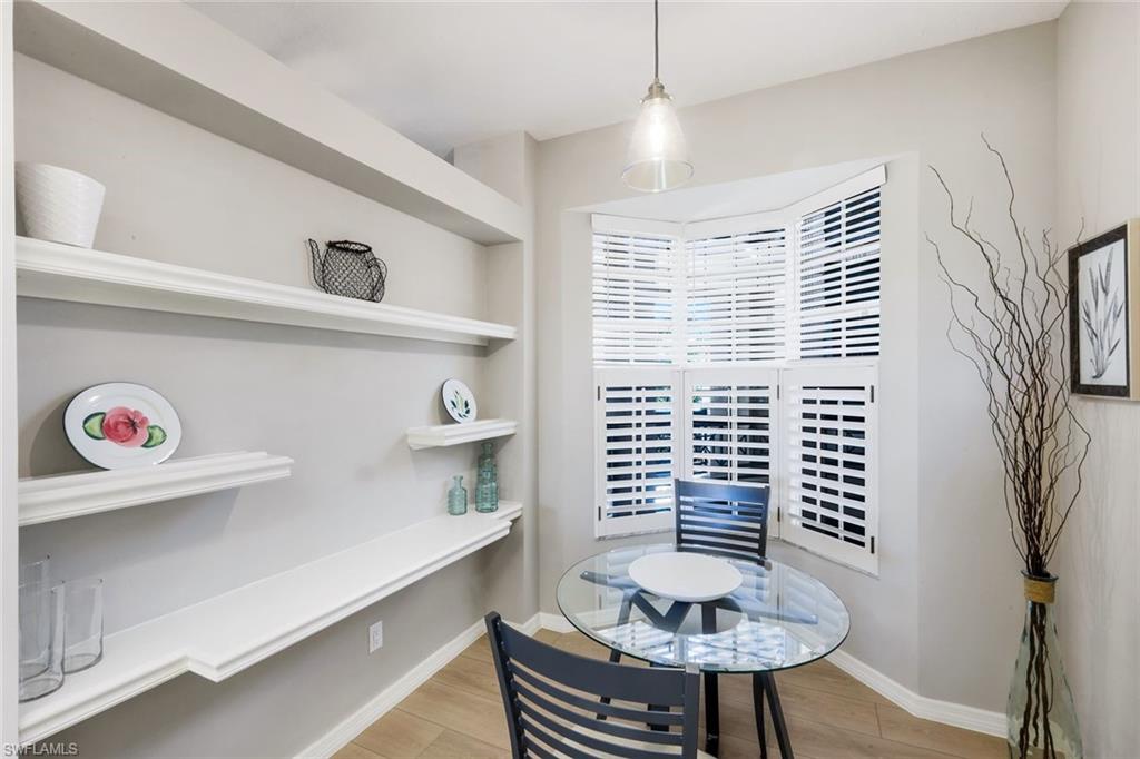 25161 Sandpiper Greens Court, Unit 203 Bonita Springs, FL 34134 - Photo 7 of 36 a view of kitchen with furniture and wooden floor
