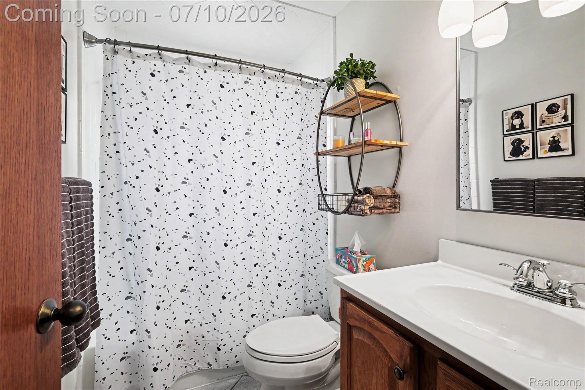 2180 Hurst Road St. Clair, MI 48079 - Photo 20 of 39 Full bathroom featuring a wood-finish vanity with an integrated sink, polished chrome faucet, and a wall-mounted mirror
