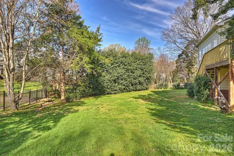 a view of yard with large trees