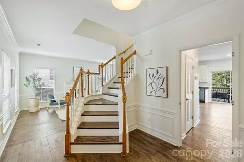 a view of entryway and hall with wooden floor