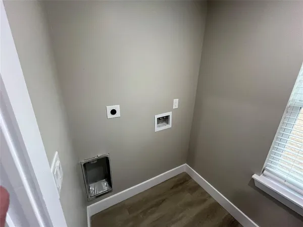 a view of a room with wooden floor and white walls