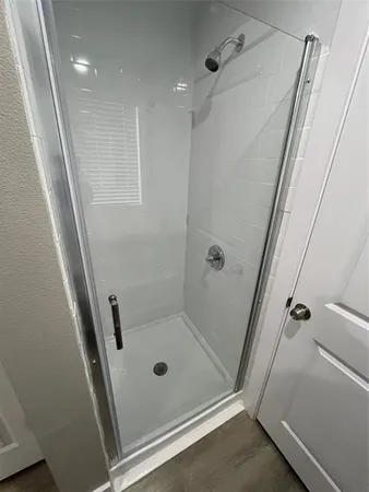 a bathroom with a shower and a tub