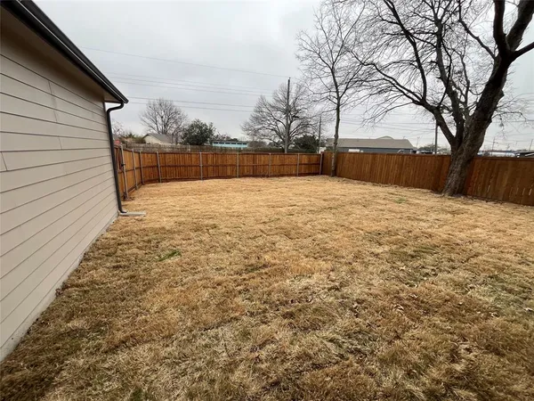 a backyard of a house with large trees