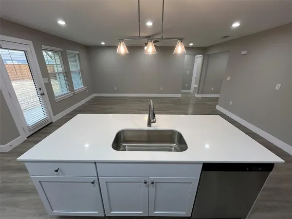 a kitchen with a sink and chandelier
