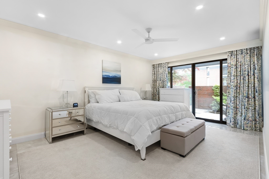 75 Grove Street, Unit 132 Wellesley, MA 02482 - Photo 11 of 20 a spacious bedroom with a bed and large window
