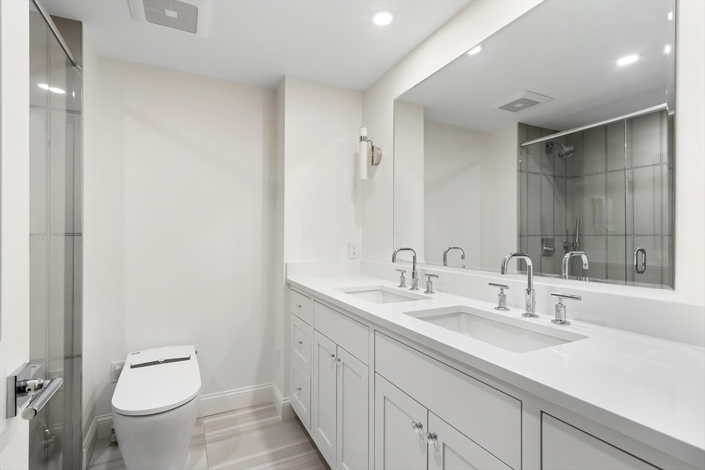 75 Grove Street, Unit 132 Wellesley, MA 02482 - Photo 12 of 20 a bathroom with a toilet sink and mirror