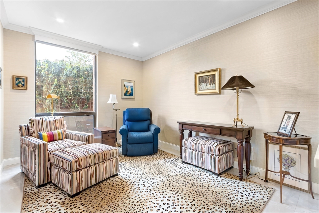 75 Grove Street, Unit 132 Wellesley, MA 02482 - Photo 13 of 20 a bedroom with furniture and wooden floor