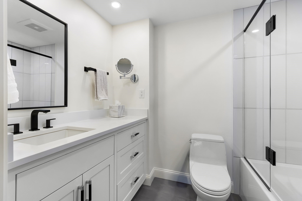 75 Grove Street, Unit 132 Wellesley, MA 02482 - Photo 15 of 20 a bathroom with a toilet a sink and mirror